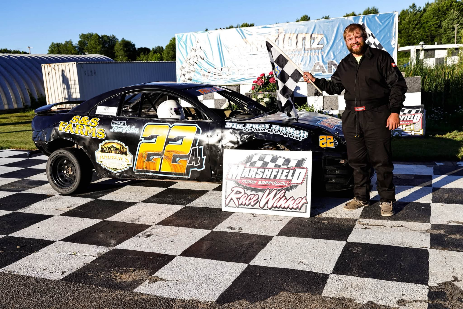 Race car and driver in victory lane at Marshfield Motor Speedway, a local racing team sponsored by KlumbWorks LLC.